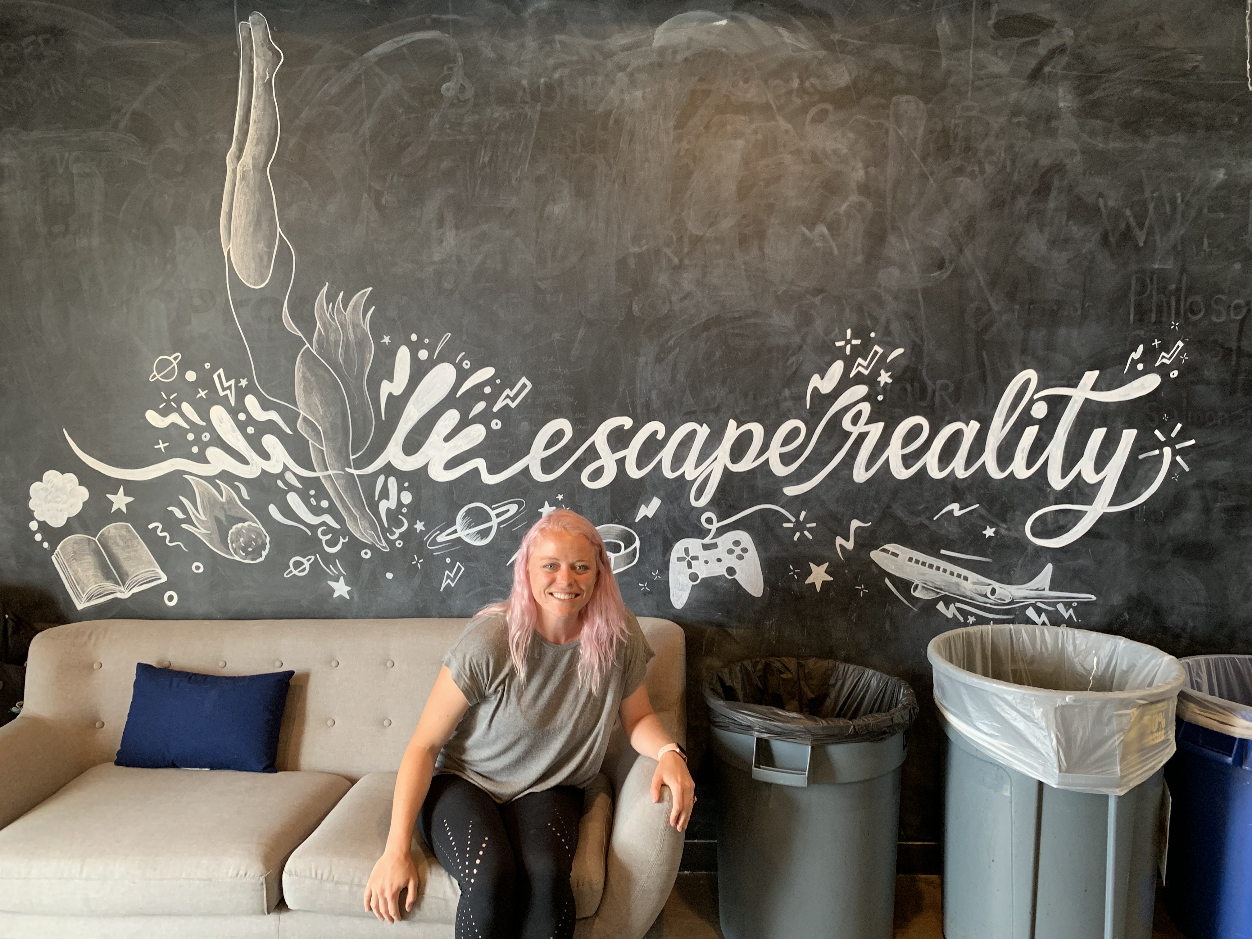 Refactor Camp 2019, Gracie Wilson seated in front of the finished chalk mural